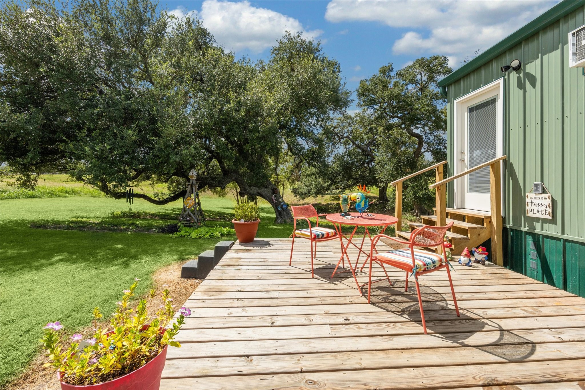 9015 Highway 36 Brenham, TX 77833 - Photo 15 of 19 a view of a patio with table and chairs potted plants and large tree