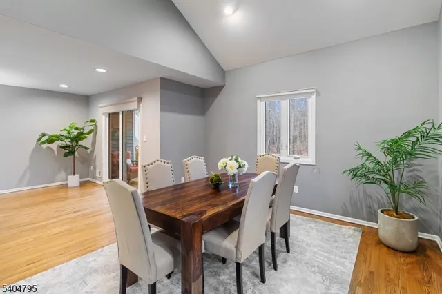a view of a dining room with furniture and a chandelier