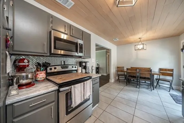 a kitchen with a stove a sink and a microwave