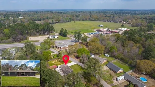 an aerial view of residential houses with outdoor space and swimming pool