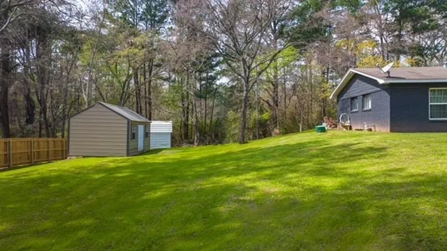 a large house with a big yard and large trees