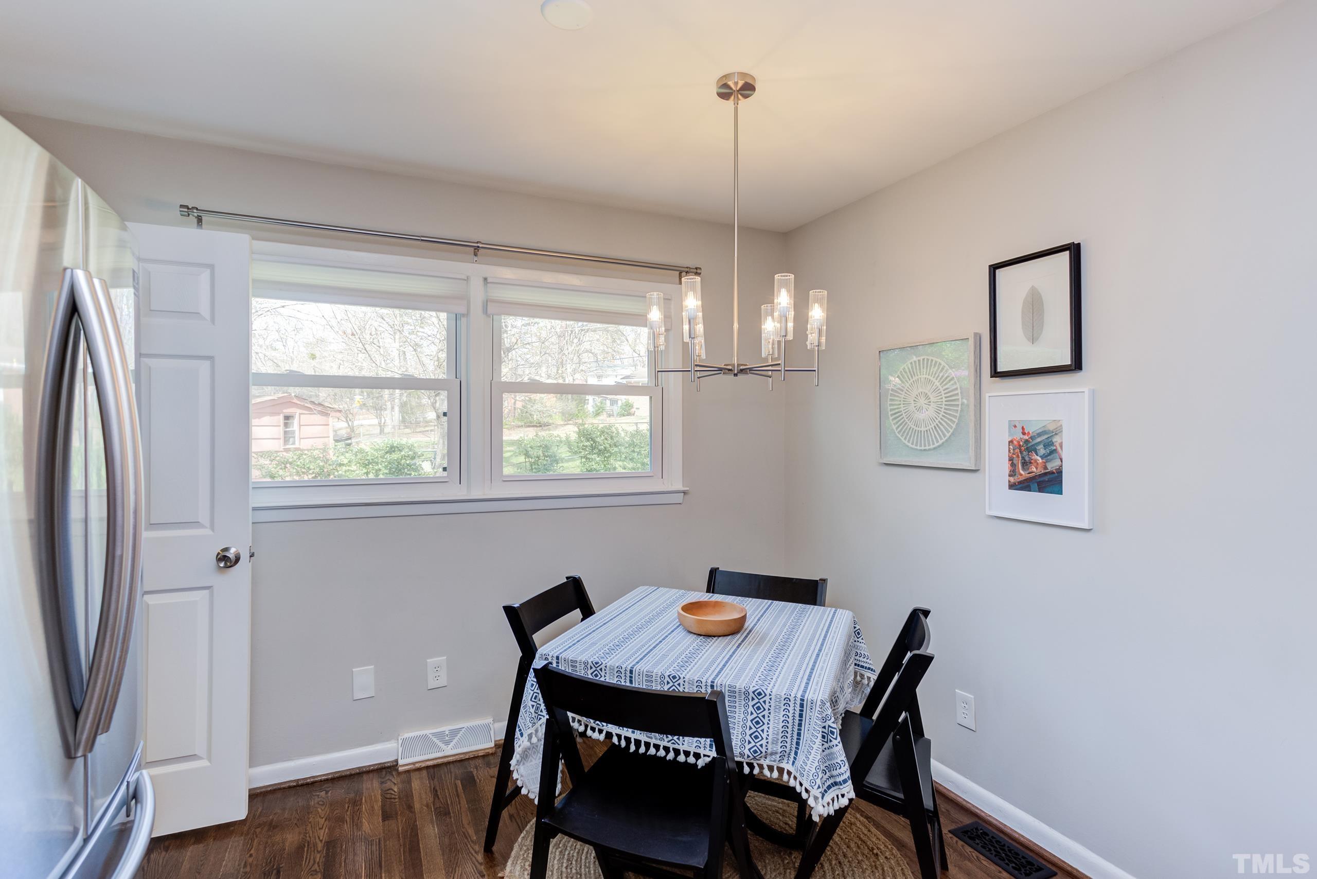 3314 Friar Tuck Road Raleigh, NC 27610 - Photo 11 of 42 a view of a dining room with furniture window and wooden floor