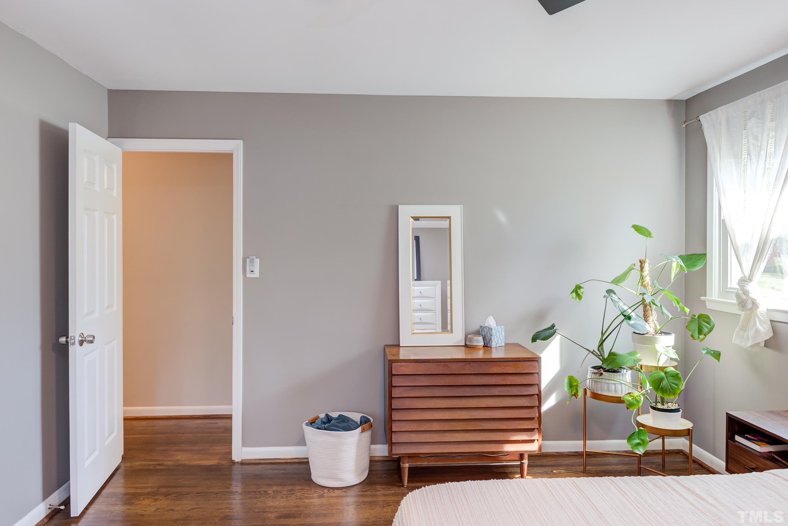 3314 Friar Tuck Road Raleigh, NC 27610 - Photo 19 of 42 a bedroom with wooden floor and a potted plant
