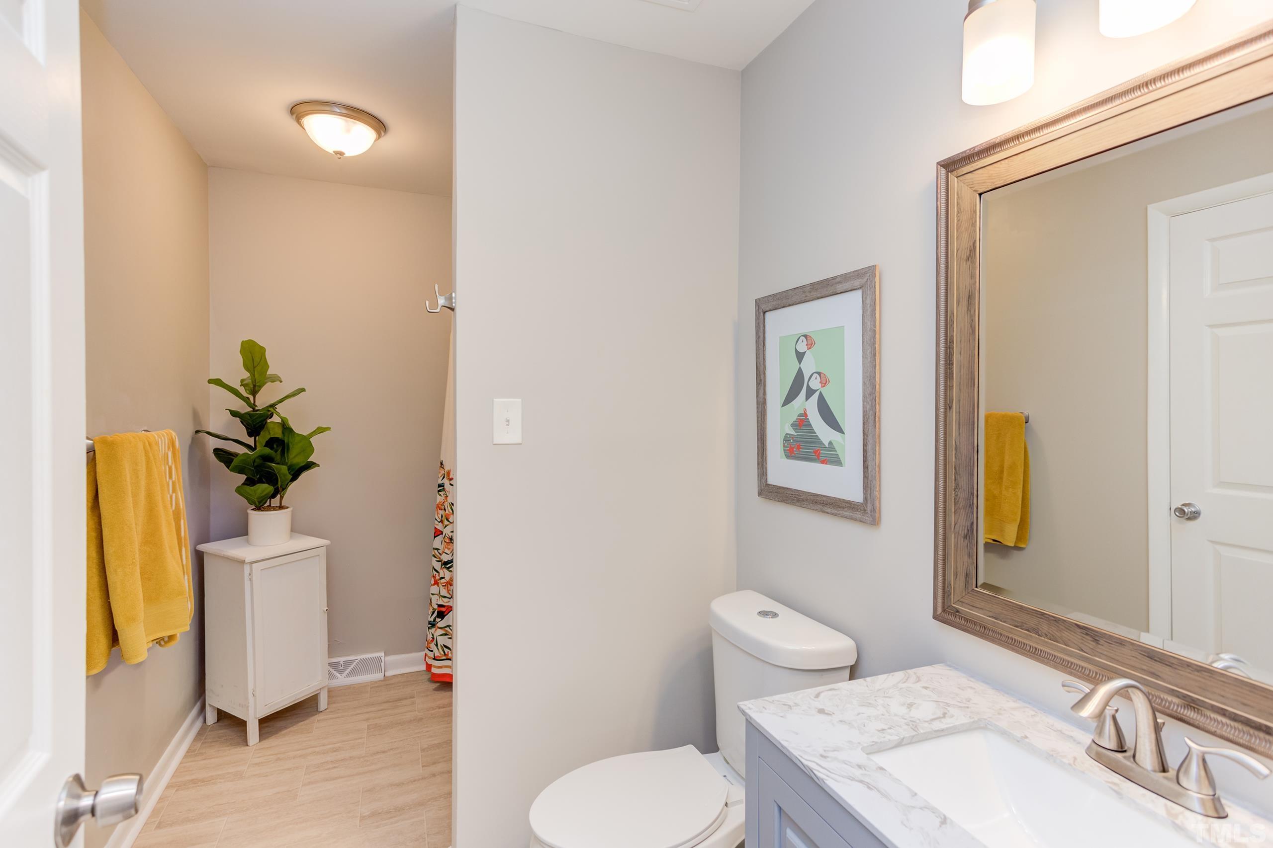 3314 Friar Tuck Road Raleigh, NC 27610 - Photo 25 of 42 a bathroom with a toilet sink and tub