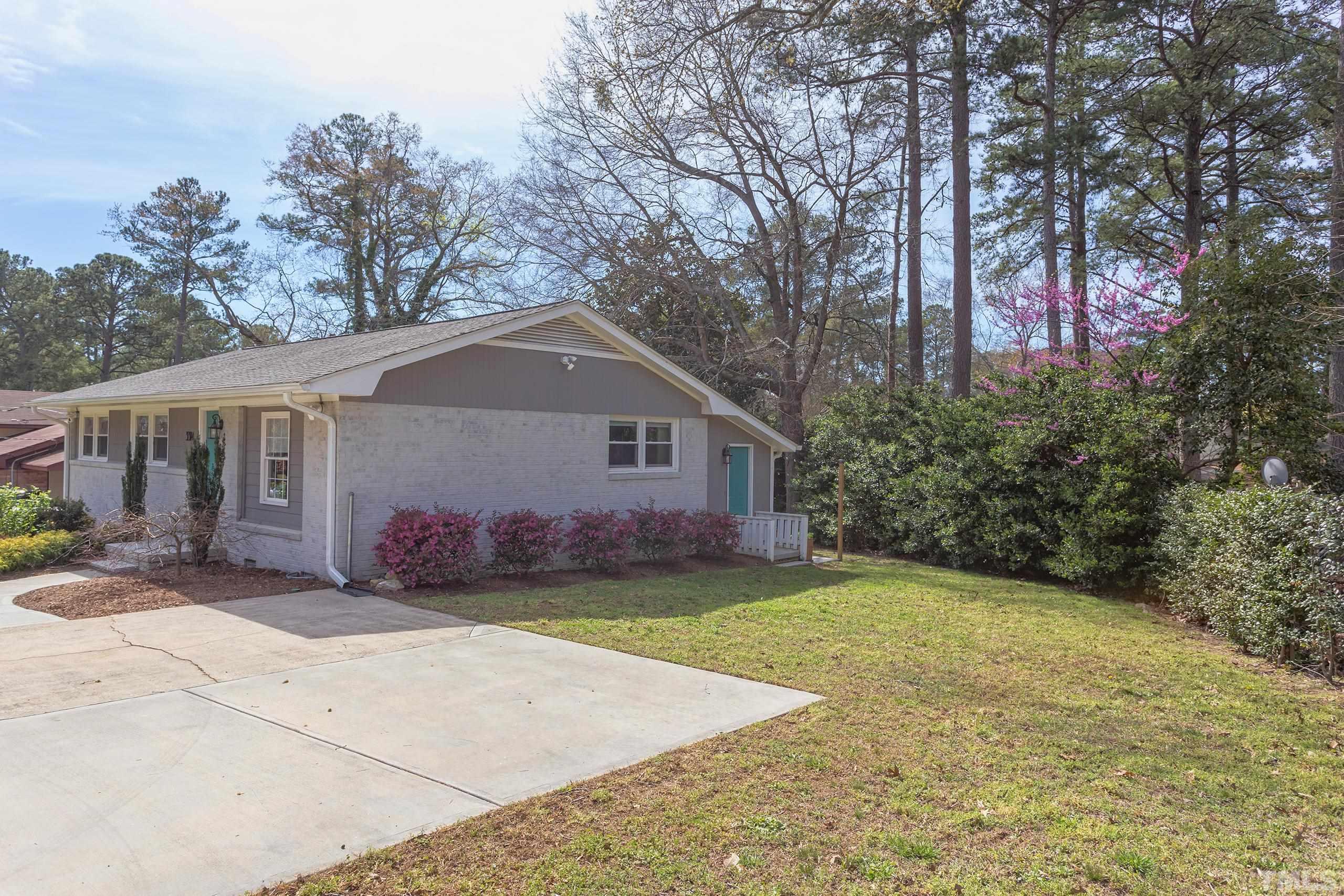 3314 Friar Tuck Road Raleigh, NC 27610 - Photo 42 of 42 a front view of a house with a yard and garage