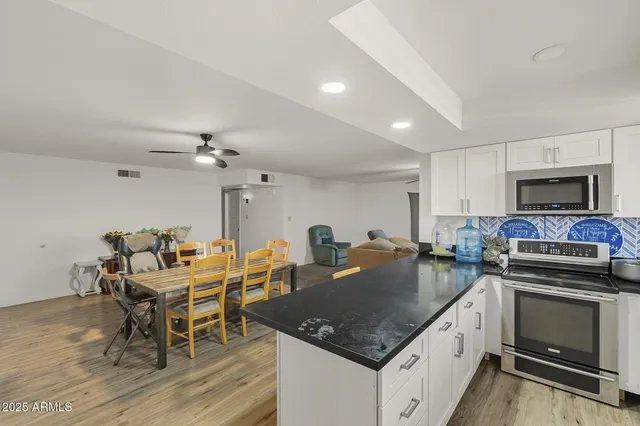a kitchen with a stove a sink and a refrigerator