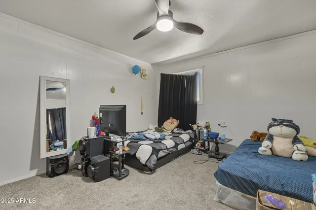 a bedroom with furniture and a chandelier
