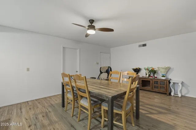 a view of a dining room with furniture and wooden floor