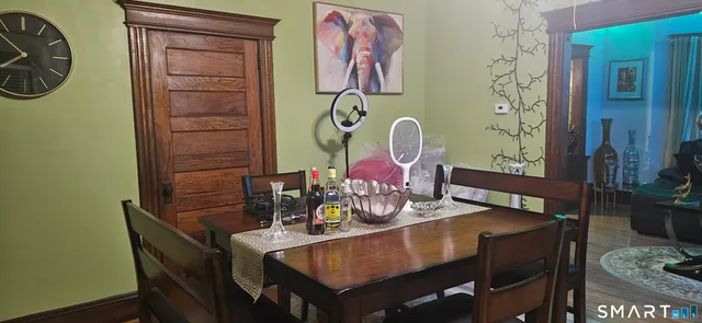 a view of a dining room with furniture and wooden floor
