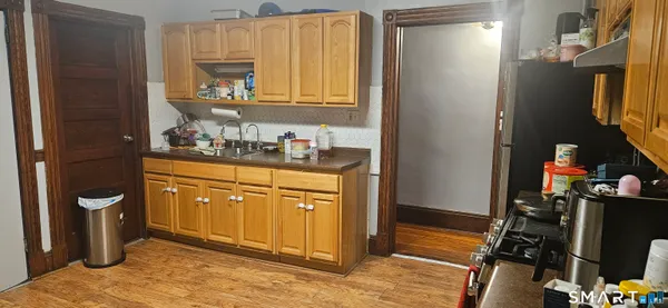 a kitchen with stainless steel appliances granite countertop a refrigerator and a stove top oven
