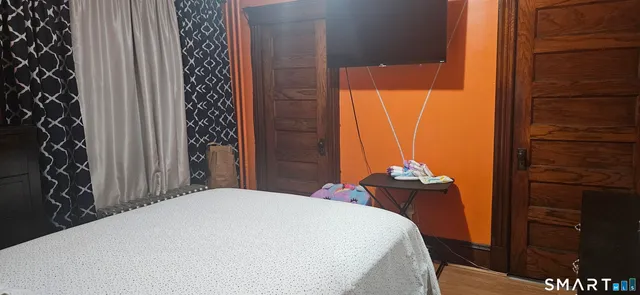 a bedroom with a bed and a window