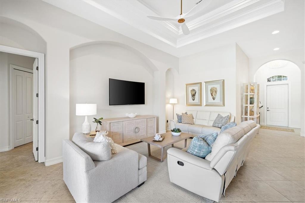 7831 Valencia Court Naples, FL 34113 - Photo 15 of 39 a living room with furniture and a flat screen tv