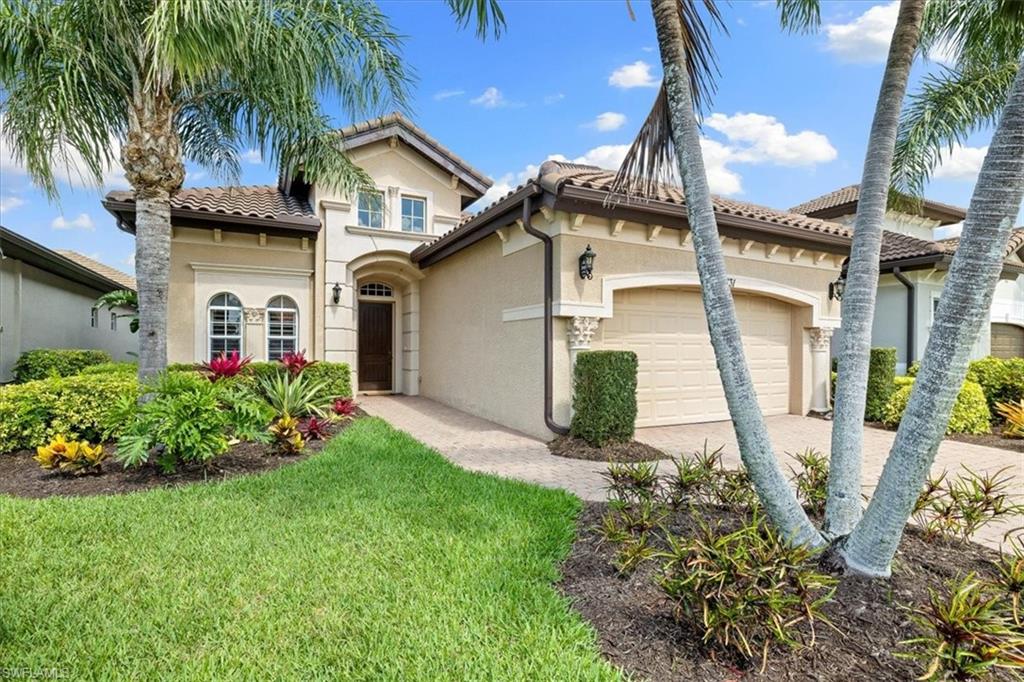 7831 Valencia Court Naples, FL 34113 - Photo 2 of 39 a front view of a house with garden