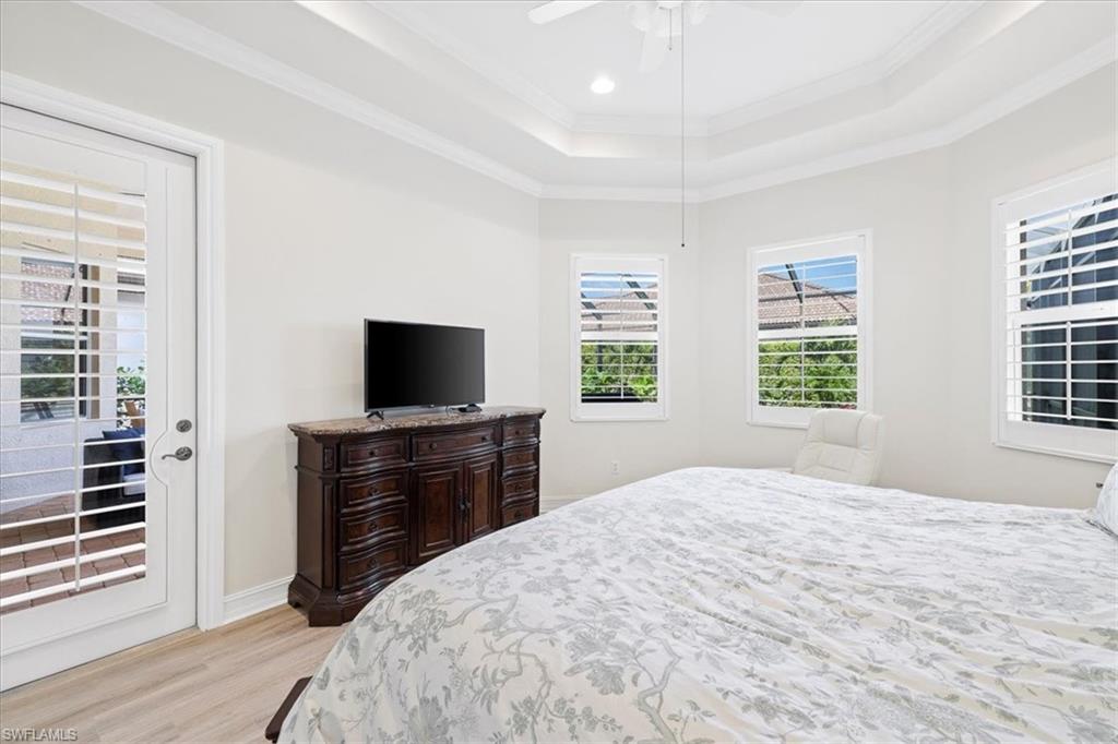 7831 Valencia Court Naples, FL 34113 - Photo 29 of 39 a bedroom with a bed and a flat screen tv