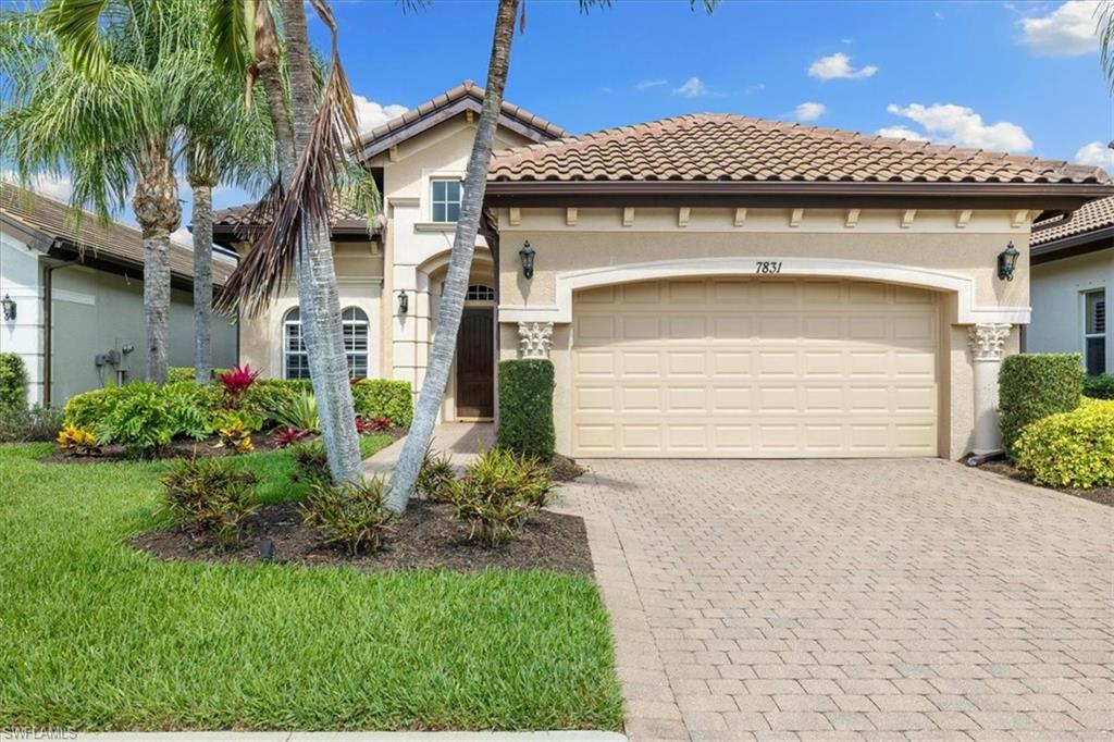 7831 Valencia Court Naples, FL 34113 - Photo 3 of 39 a front view of a house with a yard and garage