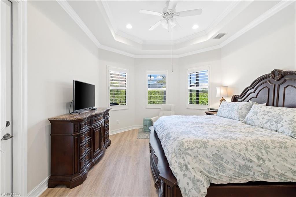 7831 Valencia Court Naples, FL 34113 - Photo 31 of 39 a bedroom with a bed and a flat screen tv
