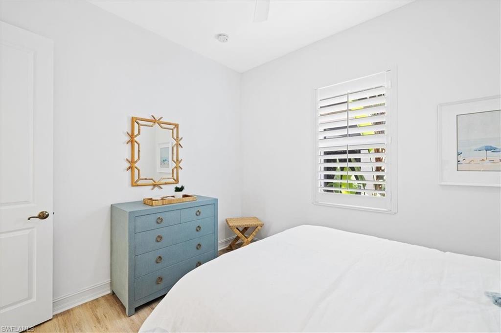 7831 Valencia Court Naples, FL 34113 - Photo 37 of 39 a bedroom with a bed and a window