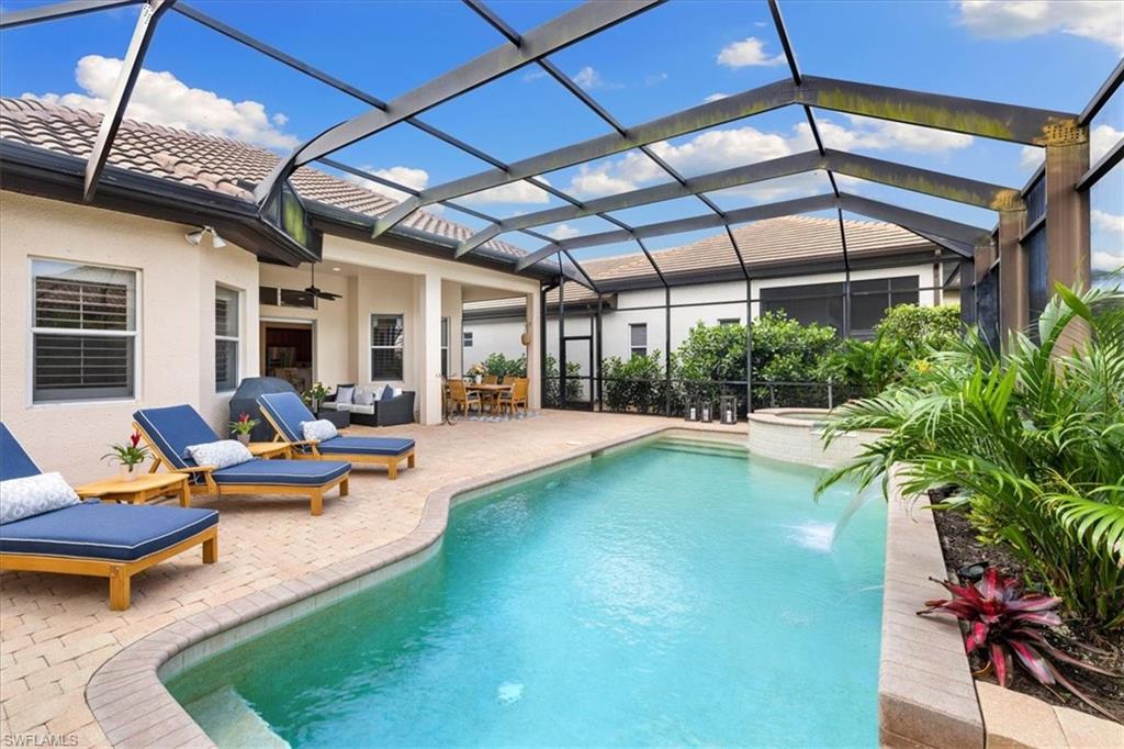 7831 Valencia Court Naples, FL 34113 - Photo 4 of 39 a view of swimming pool with outdoor seating and a patio
