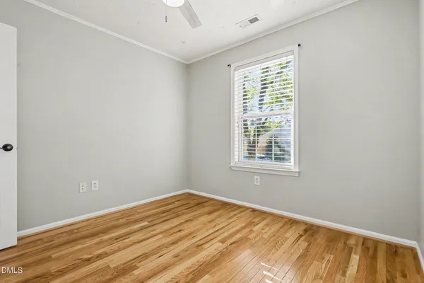 a view of a room with wooden floor