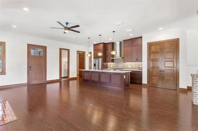 a view of a kitchen with a sink stainless steel appliances and cabinets