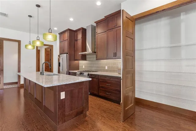 a bathroom with a sink a vanity a mirror and shower