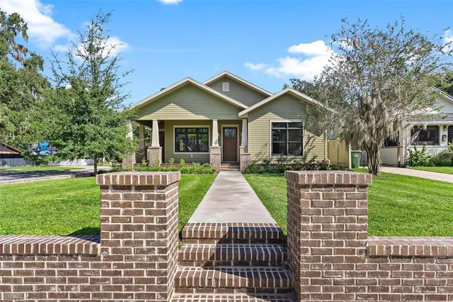 a front view of a house with a garden