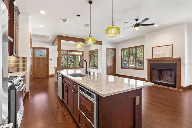 a kitchen with stove and wooden floor
