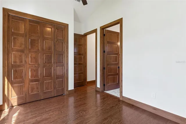 an empty room with wooden floor and closet