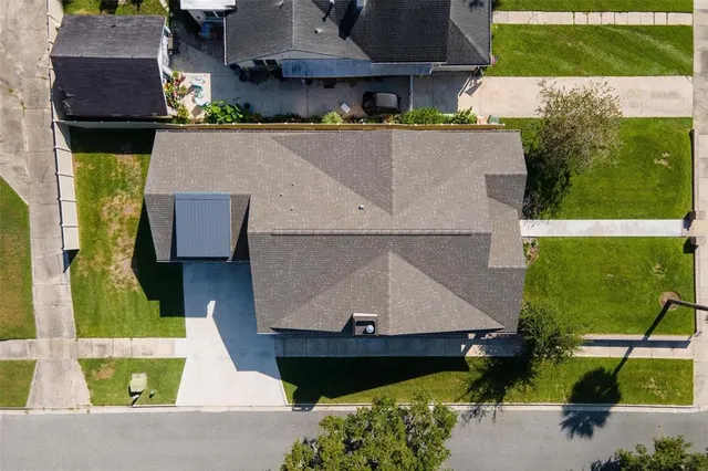 an aerial view of a house with a swimming pool