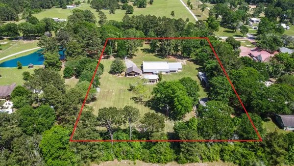 an aerial view of a house with a yard and garden
