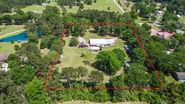 an aerial view of a house with a yard and garden