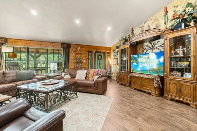 a bedroom with furniture and a large window