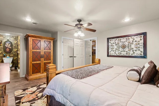 a bedroom with a large bed and a chandelier