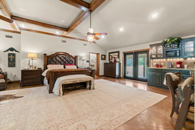 a bedroom with furniture and a chandelier