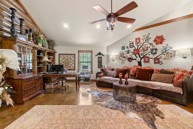 a living room with furniture or couch and a chandelier