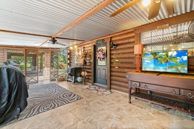 a view of a patio with table and chairs and potted plants with wooden floor and fence