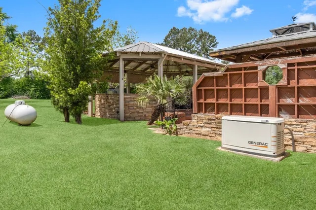 a view of a house with backyard and sitting area