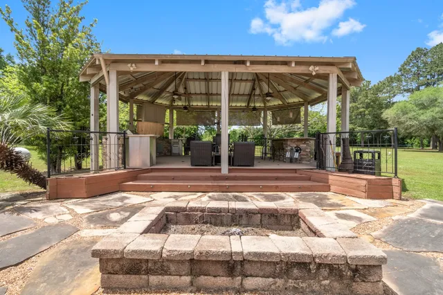 a view of a chairs and table in the patio with a fire pit