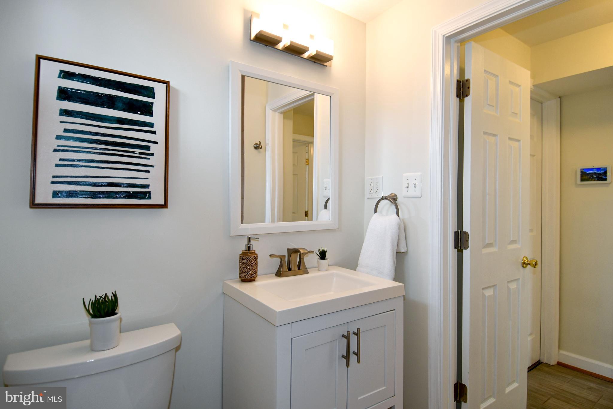 2809 Radius Road Silver Spring, MD 20902 - Photo 23 of 28 a bathroom with a toilet sink and mirror