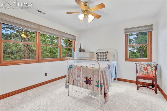 10745 Hungate Road Colorado Springs, CO 80908 - Photo 24 of 46 First of three additional upstairs bedrooms with lovely forest views.
