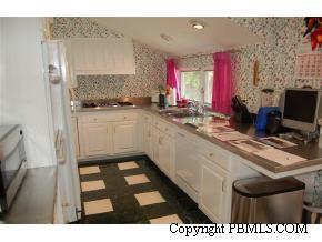 242 Kenlyn Road Palm Beach, FL 33480 - Photo 4 of 7 a kitchen that has a sink and a stove in it