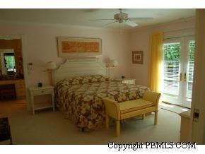 242 Kenlyn Road Palm Beach, FL 33480 - Photo 6 of 7 a bed sitting in a bedroom next to a window
