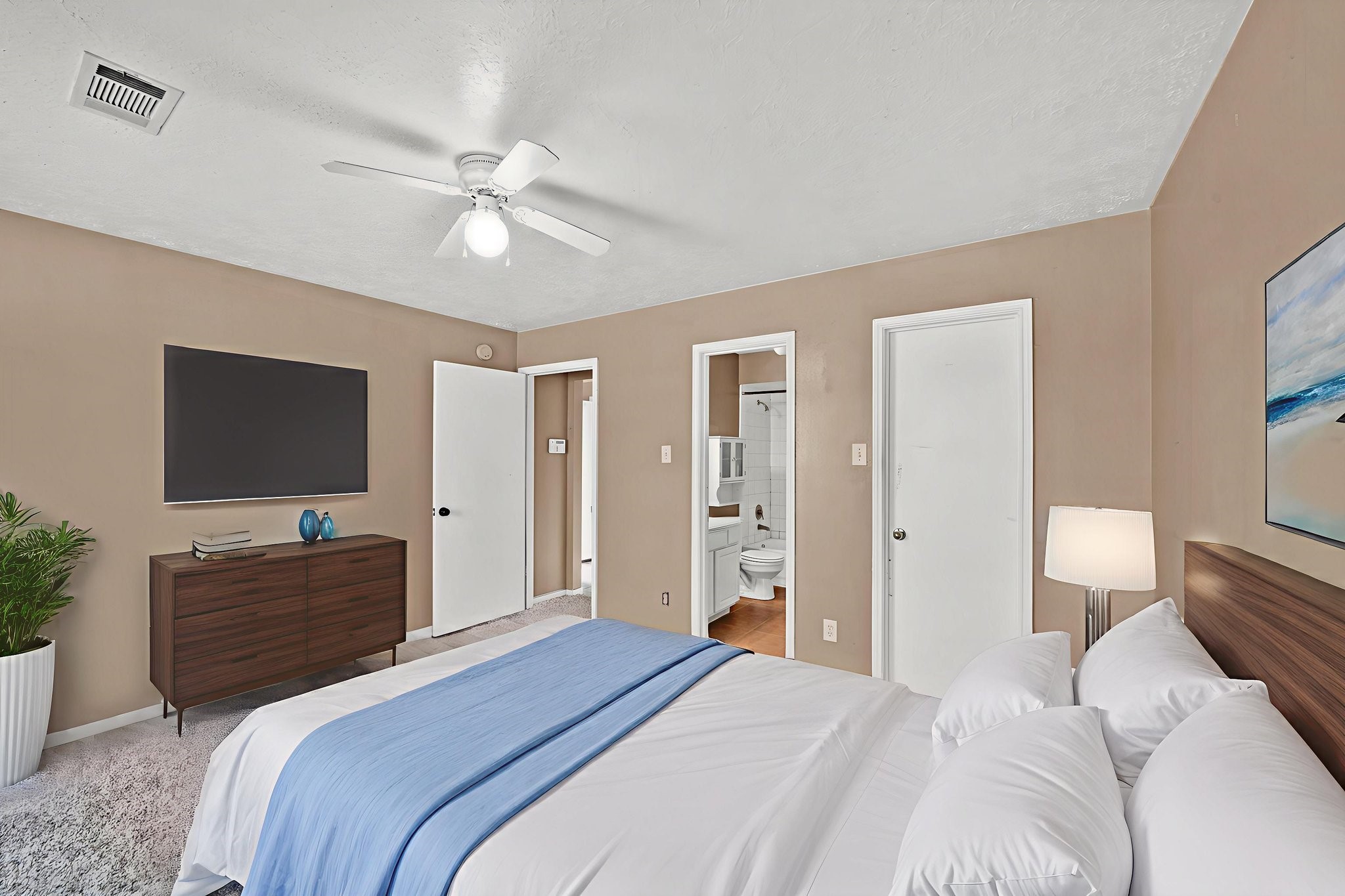 12821 Donegal Way Houston, TX 77047 - Photo 11 of 18 a bedroom with a bed and a flat screen tv