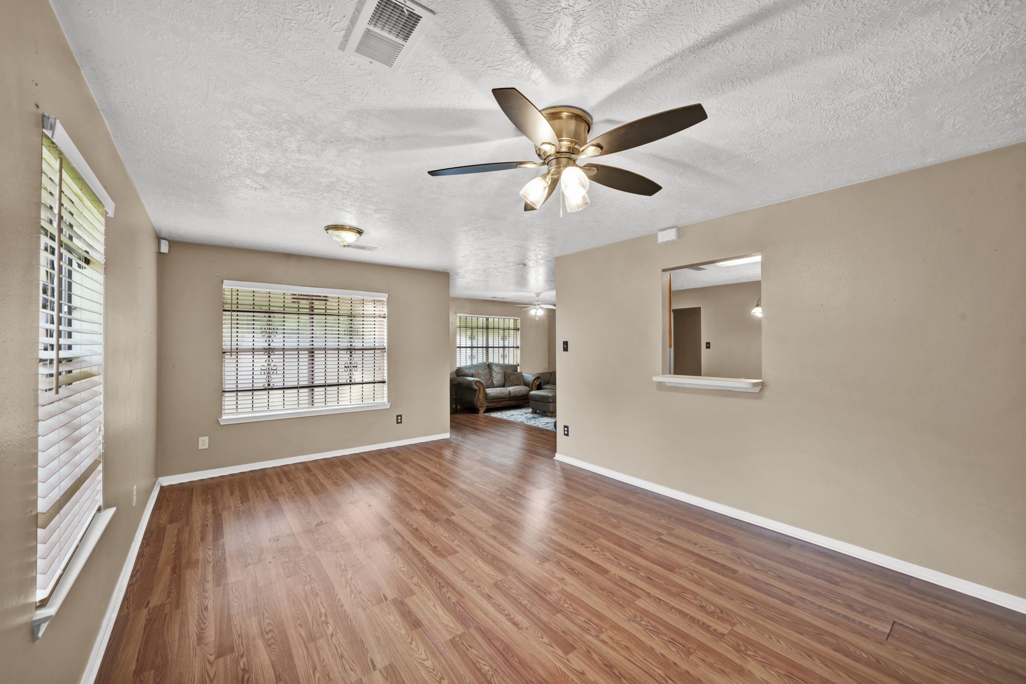 12821 Donegal Way Houston, TX 77047 - Photo 4 of 18 a view of an empty room with wooden floor and a window
