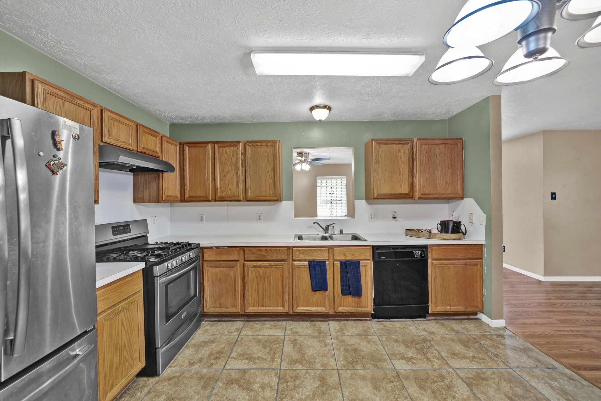 12821 Donegal Way Houston, TX 77047 - Photo 7 of 18 a kitchen with stainless steel appliances granite countertop a stove sink and cabinets