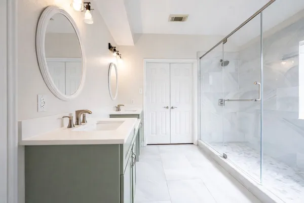 a bathroom with a sink a shower and a mirror