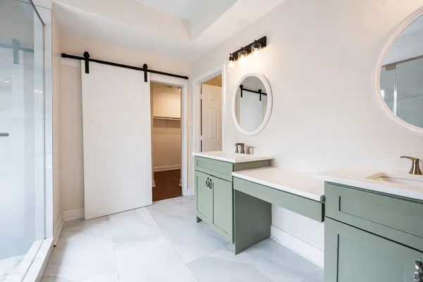 a bathroom with a double vanity sink and a mirror