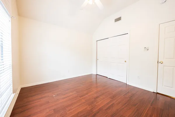 an empty room with wooden floor