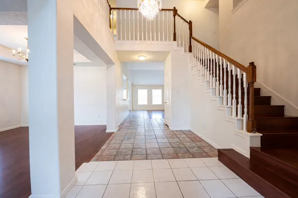 a view of entryway and hall with wooden floor