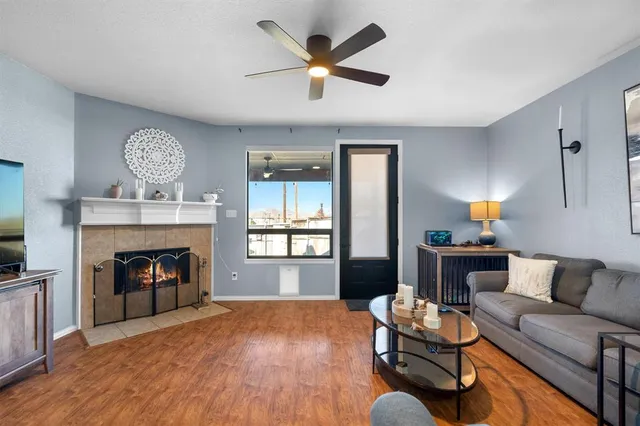 a living room with furniture a fireplace and a flat screen tv